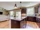 The kitchen features an island with bar seating, stainless steel appliances, and a view into the living space at 8232 Silver Vine St, North Las Vegas, NV 89085