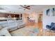 Open-concept living room boasts hardwood floors and comfortable seating that flows into dining area and kitchen at 8232 Silver Vine St, North Las Vegas, NV 89085