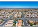A wide aerial view of the community with homes, streets, and open spaces on a bright day at 8504 W Gilmore Ave, Las Vegas, NV 89129