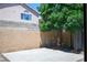 Backyard featuring a simple concrete patio and a large shade tree at 8504 W Gilmore Ave, Las Vegas, NV 89129