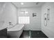 Bathroom with a modern tub, shower, and white subway tile at 8504 W Gilmore Ave, Las Vegas, NV 89129