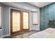 Bedroom featuring French doors with window coverings and wood-look floors at 8504 W Gilmore Ave, Las Vegas, NV 89129