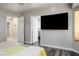 Bedroom with a television and doors leading to other rooms at 8504 W Gilmore Ave, Las Vegas, NV 89129