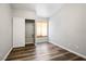 Bedroom with hardwood floors, closet with sliding doors, and a bright window providing natural light at 8504 W Gilmore Ave, Las Vegas, NV 89129