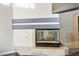 Inviting fireplace with a tiled hearth, glass screen, and modern decorative mantle shelf in the living room at 8504 W Gilmore Ave, Las Vegas, NV 89129