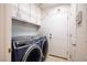 A well-organized laundry room with a modern blue washer and dryer at 8504 W Gilmore Ave, Las Vegas, NV 89129