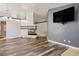 Modern living room with a fireplace, mounted TV, and hardwood floors at 8504 W Gilmore Ave, Las Vegas, NV 89129