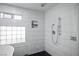 Bathroom shower with white subway tile, glass block window, and a niche at 8504 W Gilmore Ave, Las Vegas, NV 89129