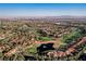 Breathtaking aerial showcasing a golf course community, complete with a serene lake and manicured green spaces at 9000 Opus Dr, Las Vegas, NV 89117
