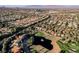 Stunning aerial view of a golf course community with lush landscaping and picturesque mountain backdrop at 9000 Opus Dr, Las Vegas, NV 89117