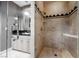 A bright bathroom featuring a walk-in shower, vanity, and framed mirror, with tile and neutral walls at 9000 Opus Dr, Las Vegas, NV 89117