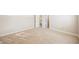 This empty carpeted bedroom has an open doorway to an adjacent room and a window for natural light at 9000 Opus Dr, Las Vegas, NV 89117