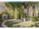 Charming two-story home with lush greenery covering the front facade at 9000 Opus Dr, Las Vegas, NV 89117