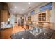Bright, open kitchen with custom cabinetry, granite counters, and modern stainless appliances at 9000 Opus Dr, Las Vegas, NV 89117