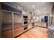 Modern kitchen with stainless steel appliances, custom cabinets, and hardwood floors at 9000 Opus Dr, Las Vegas, NV 89117