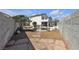 View of the backyard with stone pavers, desert landscaping, and a pool area at 9290 S Cool Creek Ave, Las Vegas, NV 89147