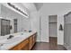 Bathroom featuring double sinks, a large mirror, and a separate closet at 9290 S Cool Creek Ave, Las Vegas, NV 89147