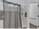 Bathroom featuring a white shower, grey shower curtain, and neutral color scheme at 9290 S Cool Creek Ave, Las Vegas, NV 89147