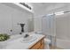 Well lit bathroom with a white sink, toilet, and shower/bath tub combo at 9290 S Cool Creek Ave, Las Vegas, NV 89147