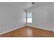 Bright bedroom featuring a window, light walls, and wood-look flooring at 9290 S Cool Creek Ave, Las Vegas, NV 89147