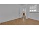Bedroom with light walls and wood-look flooring; open door shows mirror and bath at 9290 S Cool Creek Ave, Las Vegas, NV 89147