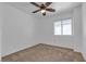 Neutral carpeted bedroom featuring ceiling fan, bright walls, and window at 9290 S Cool Creek Ave, Las Vegas, NV 89147