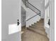 Inviting foyer with tile flooring, staircase with black iron railing leading to the upper level at 9290 S Cool Creek Ave, Las Vegas, NV 89147