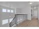 Open hallway with stairway, rod iron railing, windows and laundry area with appliances at 9290 S Cool Creek Ave, Las Vegas, NV 89147