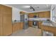 Well-lit kitchen featuring stainless steel appliances, wood cabinets, and gray countertops at 9290 S Cool Creek Ave, Las Vegas, NV 89147