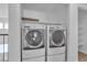 Modern, front load washer and dryer with overhead cabinets at 9290 S Cool Creek Ave, Las Vegas, NV 89147