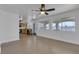Open-concept living space featuring tile flooring, ceiling fan, and a view of the modern kitchen at 9290 S Cool Creek Ave, Las Vegas, NV 89147