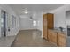 Open-concept living area with lots of natural light and hardwood-style floors next to kitchen at 9290 S Cool Creek Ave, Las Vegas, NV 89147