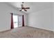 Large main bedroom with carpet, ceiling fan, and sliding door to a balcony at 9290 S Cool Creek Ave, Las Vegas, NV 89147