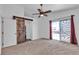 Spacious main bedroom with barn door to bathroom and sliding door to balcony at 9290 S Cool Creek Ave, Las Vegas, NV 89147