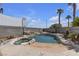 Backyard pool area with rock features, spa, and palm trees at 9290 S Cool Creek Ave, Las Vegas, NV 89147