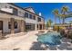 A luxury backyard featuring a pool, spa, patio, and custom architectural details at 9501 Balatta Canyon Ct, Las Vegas, NV 89144