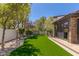 This backyard features a manicured lawn, landscaping and privacy fence at 9501 Balatta Canyon Ct, Las Vegas, NV 89144