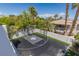 Full basketball court featuring a custom design, fencing, and manicured landscaping at 9501 Balatta Canyon Ct, Las Vegas, NV 89144