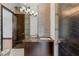 Modern bathroom vanity with dark cabinets, mosaic tile backsplash, dual sinks and unique lighting at 9501 Balatta Canyon Ct, Las Vegas, NV 89144