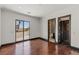Open bedroom featuring wood floors, closet and access to a patio with outdoor views at 9501 Balatta Canyon Ct, Las Vegas, NV 89144