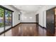 Spacious room with rich hardwood floors, stylish wall sconces, and a private balcony entrance at 9501 Balatta Canyon Ct, Las Vegas, NV 89144