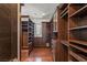 Spacious walk-in closet featuring custom wood shelving and drawers for ample storage at 9501 Balatta Canyon Ct, Las Vegas, NV 89144
