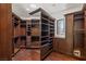 Well-organized walk-in closet with custom wood shelves and drawers, perfect for storage at 9501 Balatta Canyon Ct, Las Vegas, NV 89144