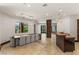 Elegant dining area featuring stone accent pillar, modern chandelier and bar area with sink at 9501 Balatta Canyon Ct, Las Vegas, NV 89144