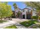 Two story home featuring a brick driveway, manicured lawn, and desert landscaping at 9501 Balatta Canyon Ct, Las Vegas, NV 89144