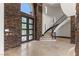 An elegant foyer with a grand staircase and stylish black metal bannister at 9501 Balatta Canyon Ct, Las Vegas, NV 89144