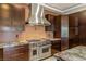 Chef's kitchen with stainless steel appliances, custom cabinetry, and a professional-grade range at 9501 Balatta Canyon Ct, Las Vegas, NV 89144