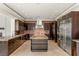 Gourmet kitchen features an oversized island, custom cabinetry, and professional-grade appliances at 9501 Balatta Canyon Ct, Las Vegas, NV 89144