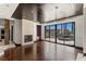 An open living room with a fireplace and glass doors leading to backyard pool at 9501 Balatta Canyon Ct, Las Vegas, NV 89144