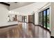 Open concept living space featuring hardwood floors, recessed lighting and walls of glass at 9501 Balatta Canyon Ct, Las Vegas, NV 89144